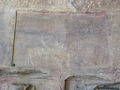 गुफ़ा की दीवार पर उत्कीर्ण लिपि